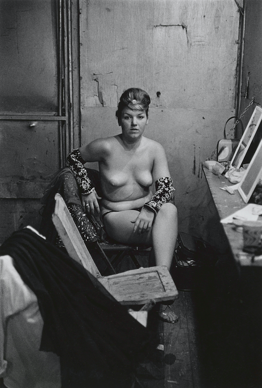 Stripper with bare breasts sitting in her dressing room, Atlantic City, N.J. 1961